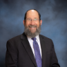 Headshot of Rabbi David Jacobson smiling.